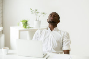 conscious breathing at desk - man